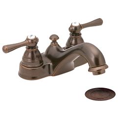 Llave de dos manerales con acabado en bronce aceitado y arco bajo para baño